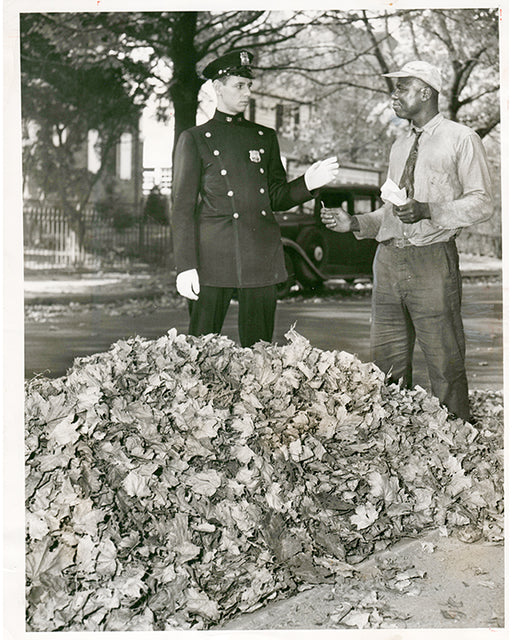 Patrolmen Arthur Ury informs John Edwards at 69-110th Street in Forest Hills that it is illegal to burn leaves.