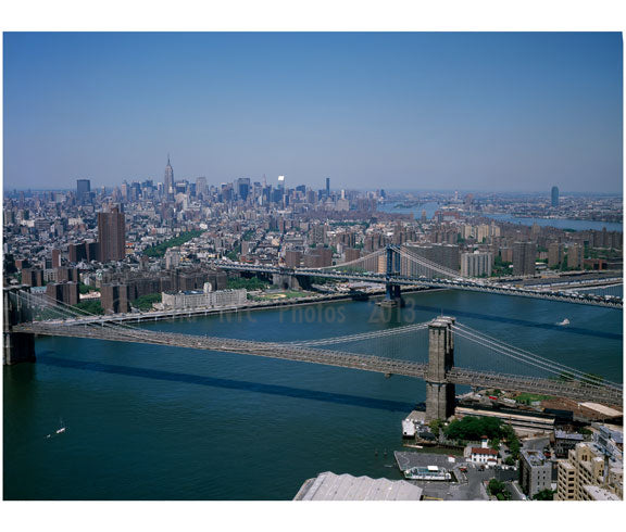 Aerial view of Manhattan, looking toward Brooklyn with Brooklyn & Manhattan bridges in view crossing the East River Old Vintage Photos and Images