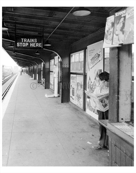 Boy reading the news  paper at the train station Old Vintage Photos and Images
