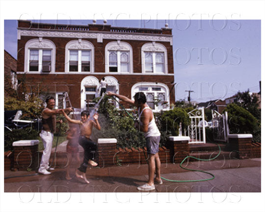 Family playing with water hose 1980's Old Vintage Photos and Images