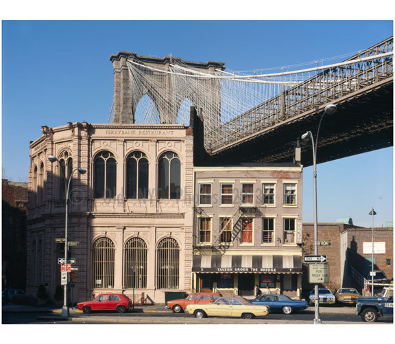 Brooklyn Bridge -  view of Brooklyn Tower emerging behind commercial buildings on the corner of Front Street & Camden Plaza Old Vintage Photos and Images