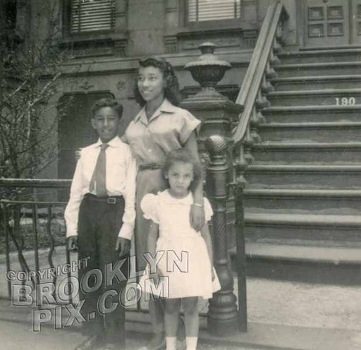 Family in front of brownstone, 1940s