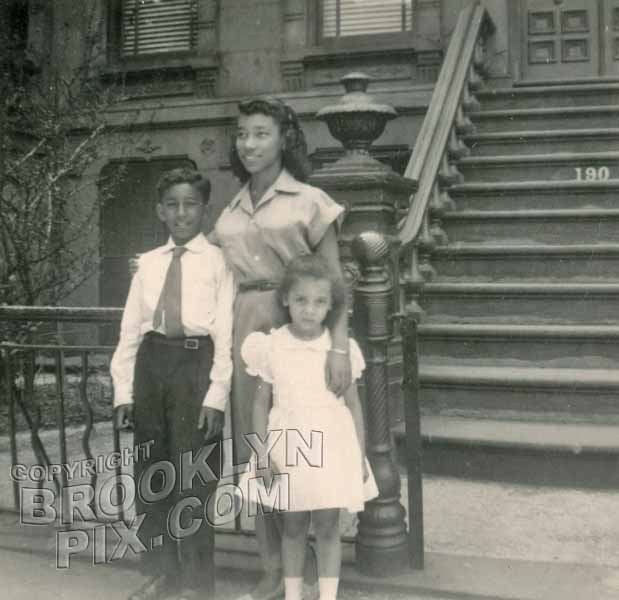 Family in front of brownstone, 1940s
