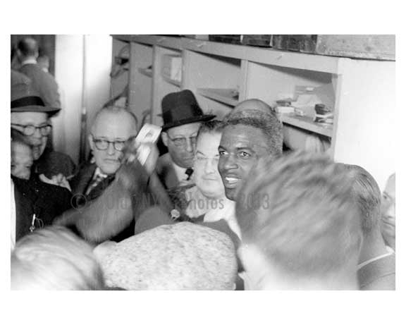 Jackie Robinson in the Dodgers locker room with the Press after the game 1
