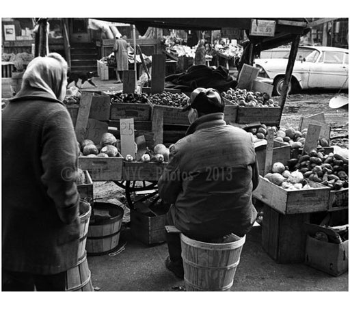 Produce vendor - bundled up against the cold, sits on a bushel basket by his pushcart. Old Vintage Photos and Images