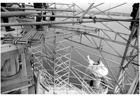 Statue of Liberty - view of new flame & torch assembly being hoisted into place November 25, 1985 Old Vintage Photos and Images