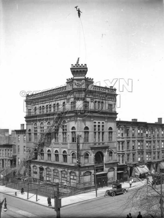 Steeplejack replacing gilded eagle atop flagpole of Acme Hall, Seventh Avenue and Ninth Street, c.1912 Old Vintage Photos and Images