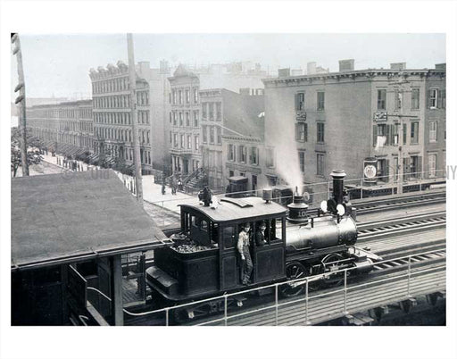 Trains on raised platform with city in view Old Vintage Photos and Images