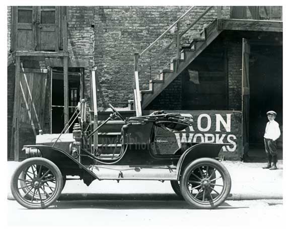 Upclose shot of a (now) classic Ford outside of Iron Works on 7th Avenue  - Midtown Manhattan - 1914 Old Vintage Photos and Images